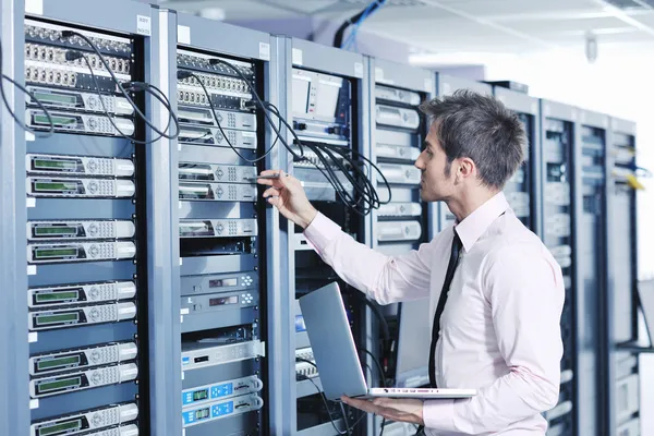 depositphotos 7964984 Businessman with laptop in network server room